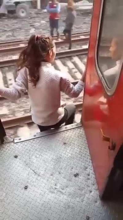 A girl jumping from a Moving train