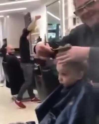 Guys singing not to make the baby cry during his haircut