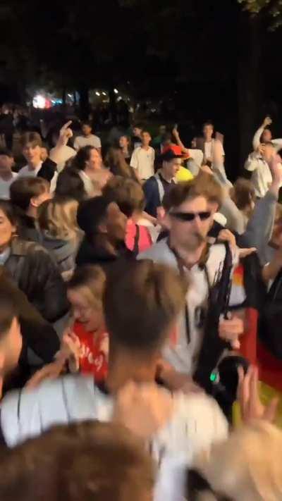 Germany fans celebrating with a saxophone player