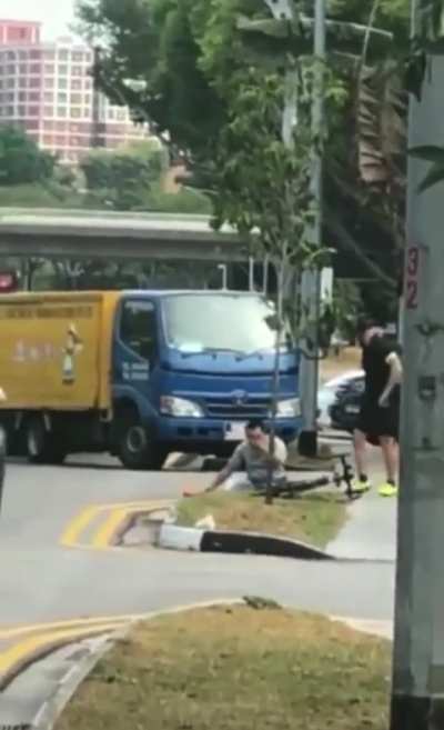 Crazy driver tries to run a cyclist over and then jumps out the truck to confront him only to get put on his ass.