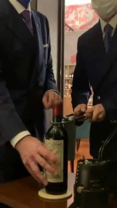 Opening a $15,000 bottle of Petrus, 1961 with heated tools. This method is used to make sure that the cork stays intact.