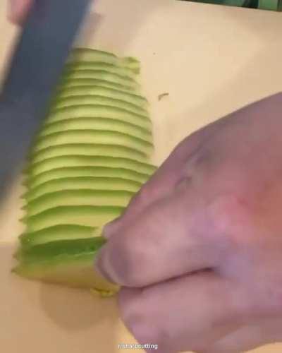 Man slicing avocado for sushi