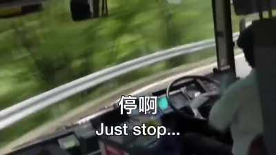 Man rapidly driving bus down a hillside road