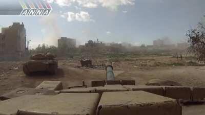 Syrian Army armored column rolls through Daraya engaging targets while moving through dense packed city streets - 3/1/2013