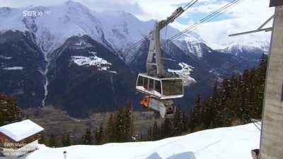 Gondola lift transporting a garbage truck for daily collection to a remote village in Switzerland