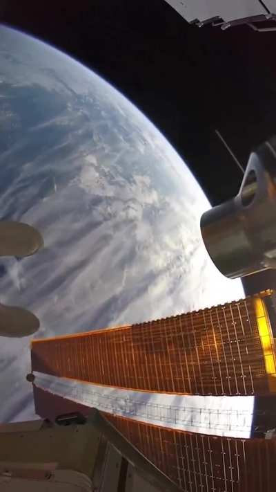 The view of Earth seen by an astronaut while performing maintenance outside the International Space Station.