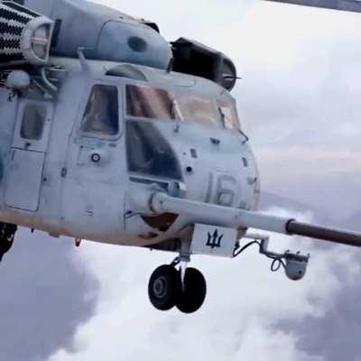 CH-53E Helicopter in flight refueling while hauling a humvee.