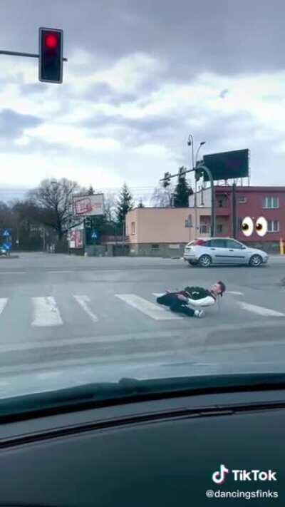 He is not on skates, and in the crosswalk