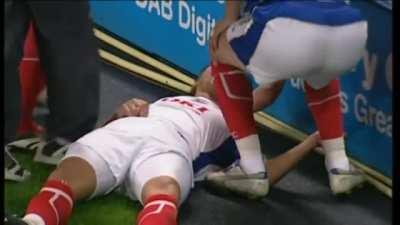 Soccer Player knocks his opponent out during a match.