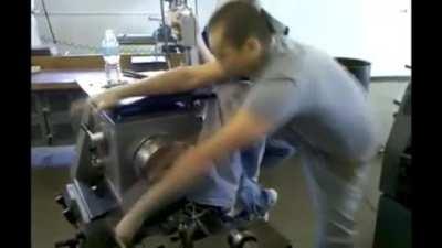 Never try to out muscle an industrial lathe.