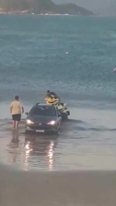 using a car to put a jet ski in water