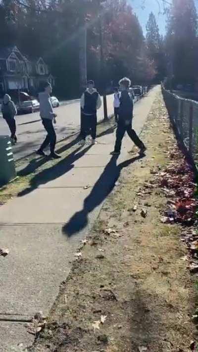 kid in light grey talks shit then complains about his ear in fight then kid in red joins in because other kid pussys out