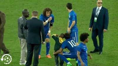 While the child entering the field is being escorted off the field by the security guards, the football players see the situation and intervene.