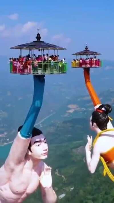 ‘Flying Kiss Ride’ in China is made of two giant statues, overlooking a 3,000 ft. cliff