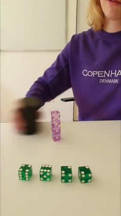 Stacking dice using a cup.