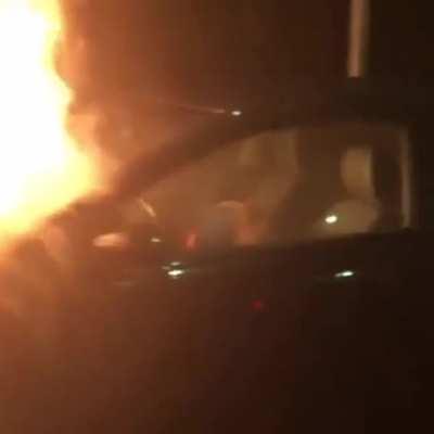 Russian guy casually sleeping in car that's on fire