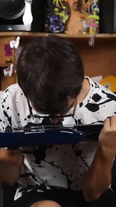 Stevie T licking his guitar strings