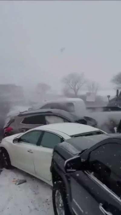 Ice on a highway causes an accident blockage leading to a large pileup