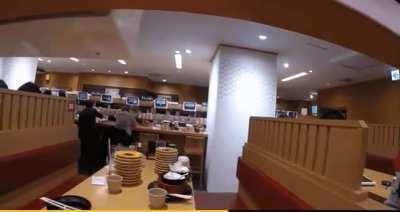 Guy puts a GoPro on a sushi conveyor belt