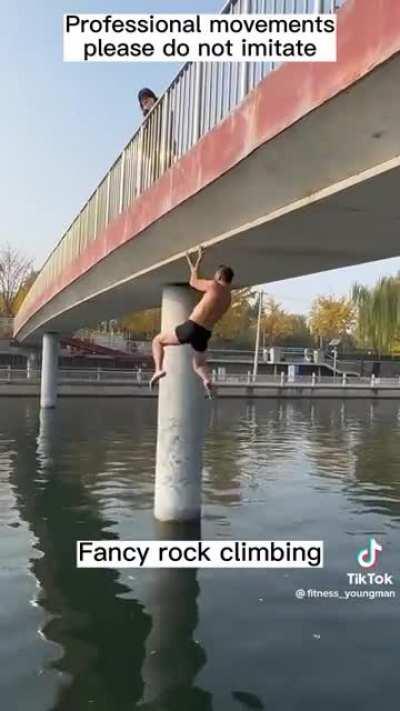 Man climbs bridge with his fingers