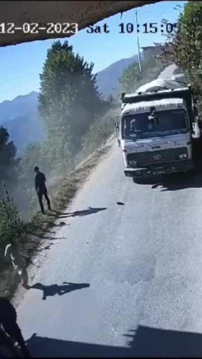 to overtake truck while man peeing on road side