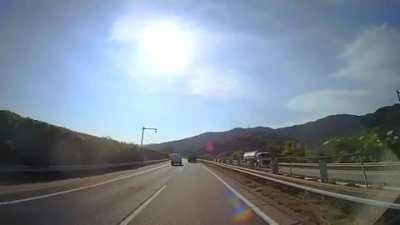 Car flies into Japanese Tour bus