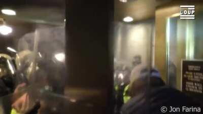 Insane footage of riot cops shoving terrorists out of a congressional building tunnel — shot by journalist Jon Farina of Status Coup