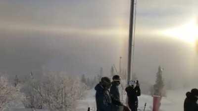 Sun rays refracting through ice crystals in air