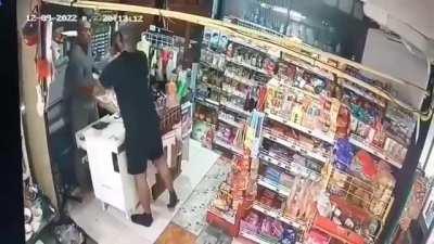 Idiot punches store owner who has a shotgun pointed at him
