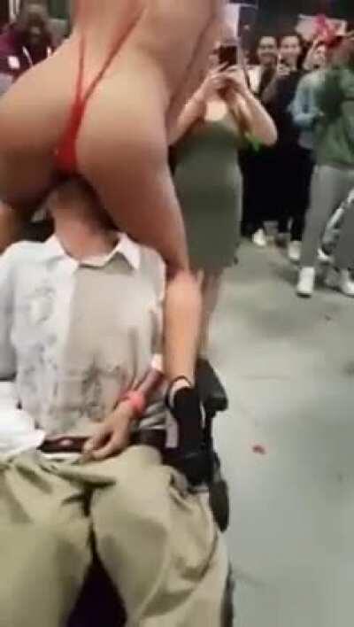 Adriana Chechik giving a disabled fan a taste