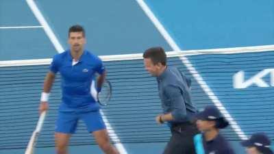 Novak Djokovic playing cricket on the Tennis court.
