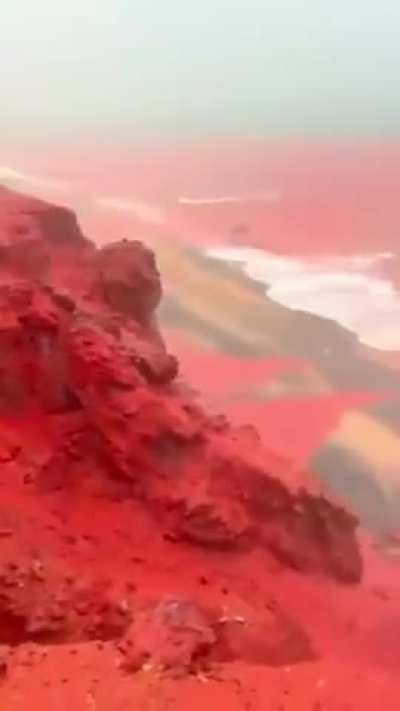 Heavy December Rains Turn Hormuz Island’s Red Beach Sea Bright Red in Rare Natural Sight