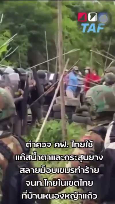 Cambodian protesters armed with sticks clash with Thai riot police before Thai police deployed tear gas.