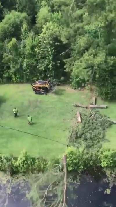 Tree topper uses a zip line technique to bring felled tops to shoreline