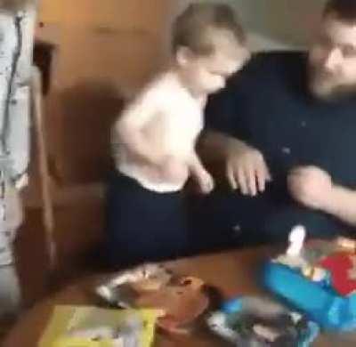 Kid snuffs out his birthday candle with his face.