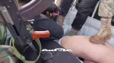 Syrian government men (former rebels) abuse a group of men they have captured in their operations against remnants of Assad and protesters, including one whom appears to be underage.