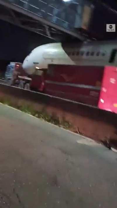 Air India aircraft gets stuck under a pedestrian footbridge while being transferred outside the New Delhi airport