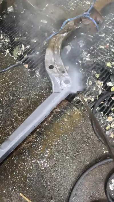 Pressure washing the rust off this Buick GS frame after a chemical rust removal dip.