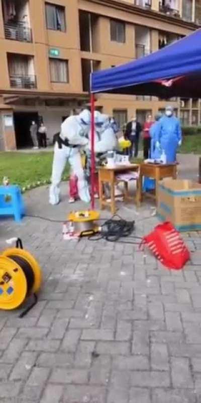 Chinese Covid police forcing a lady to do mandatory Covid testing in Chongqing, China