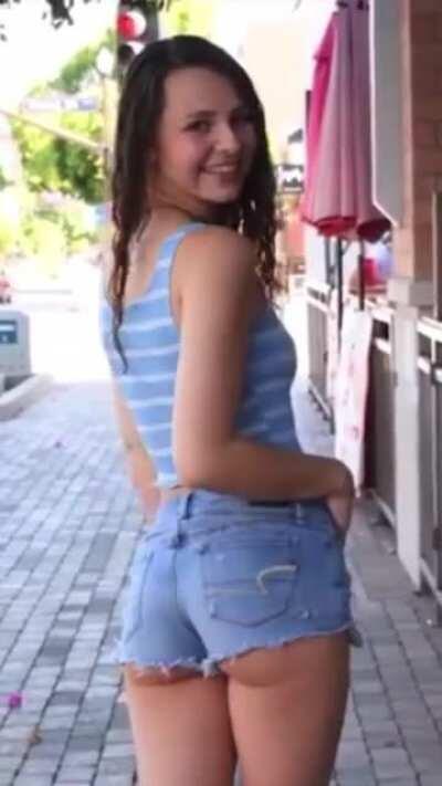 Adorable girl teasing in her shorts