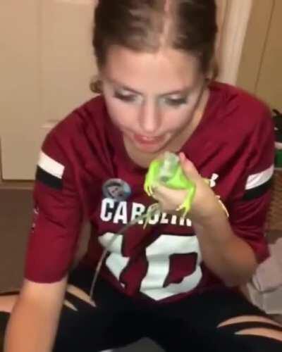 Drunk girl messing with iguana