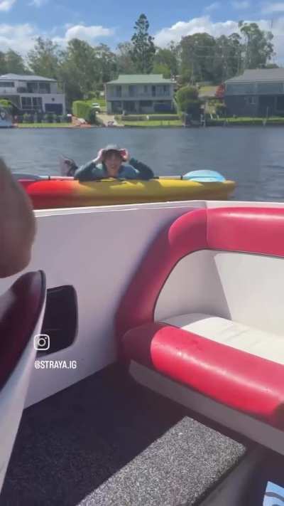 Angry kayaker tries to splash dude in a boat