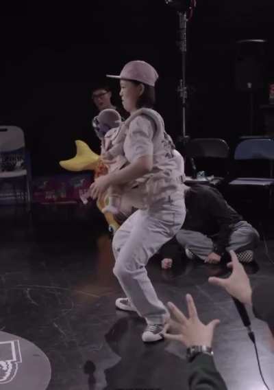 A mom doing the ‘waves’ while carrying her baby in carrier 