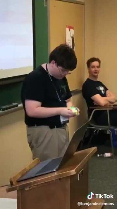 Class freaking out at a fellow classmate solving a Rubik's cube