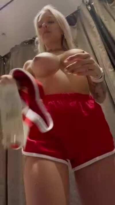 in the dressing room of a shopping center))