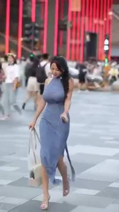 Busty beauty walking in the street