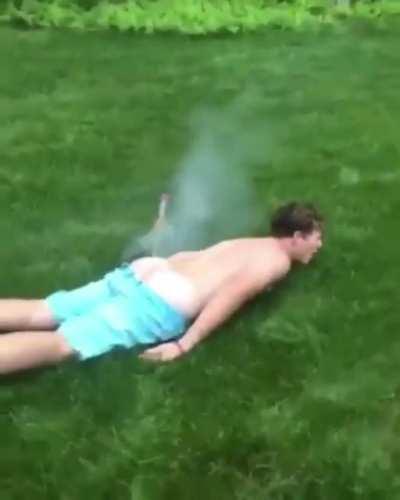 Guy lighting off a bottle rocket from his ass crack