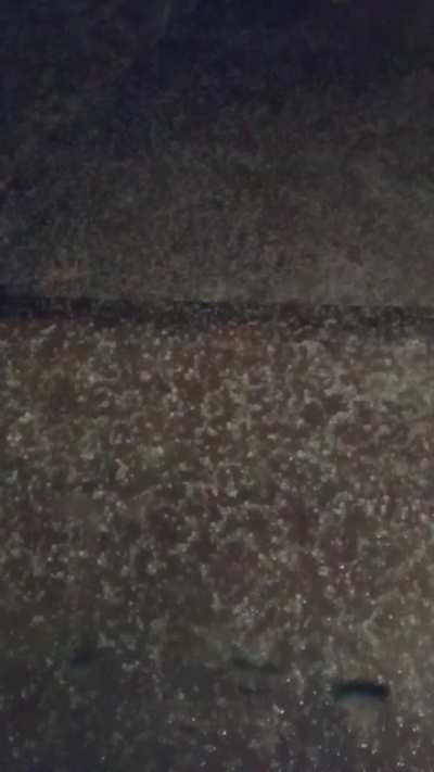 Huge flash of lightning during a hailstorm