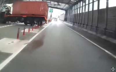 Cab of a red truck gets unanchored and deformed while car crash