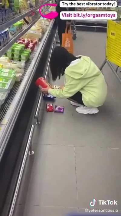 Controlling her vibrator at a shop